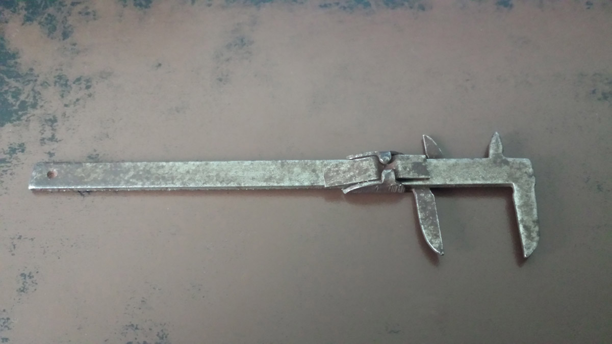 Bottom view of a vintage caliper.