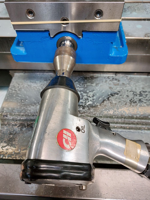 The adapter mounted on the impact wrench and the vise.